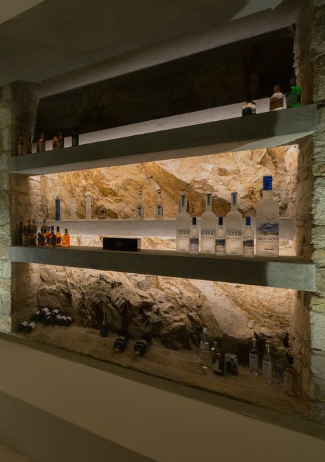 Basement ultra modern bar with real stone walls, hidden lighting, concrete shelves. Stone Wall Shelves, Stone Bar Backsplash, Stone Wall Bar, Stone Bar Ideas, Stone Wall Lighting, Lighted Bar Shelves, Concrete Shelves, Stone Shelves, Apartment Bar