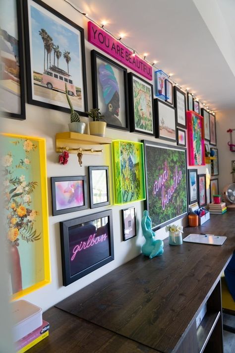 Maximalism at its finest. This gallery wall features bright and fun artwork that is framed with neon acrylic frames with solid black mixed in, creating a fun and creative wall. Colorful Art Gallery Wall, Vintage Living Room Wall Color, Maximalist Makeup Room, Modern Maximalist Decor Office, Diy Maximalist Wall Art, Neon Gallery Wall, Maximalist Photo Wall, Random Gallery Wall, Colorful Gallery Wall Living Room