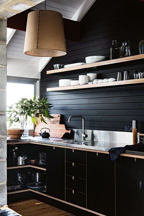 a chic black farmhouse kitchen with wooden planks, sleek black plywood cabinets and a metal countertop plus a burlap lamp Stainless Steel Benchtop, Black Plywood, Accent Wall In Kitchen, Moody Kitchen, Cabinets Makeover, Plywood Kitchen, Plywood Interior, Black Kitchen, Kitchen Remodel Idea