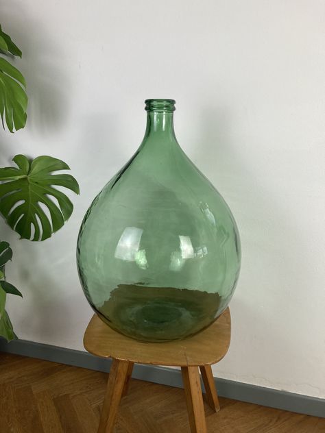 XXL Vintage Handblowen Demijohn / Vintage Glass Home Decoration / Large Clear Green Glass Bottle / Old Farmhouse Glass Bottle / Antique Vase Beatiful XXL old green glass demijohn in perfect vintage condition. Handblowen with a lot of and has some manufacture imperfections like small bubbles or varying glass thickness. Dimensions diameter: 42 cm height: 60 cm Material: handblowen glass Every item will be packed with care. We try to reuse packaging as much as possible. For more great vintage piece Glass Jugs Decor, Jug Decor, Reuse Packaging, Dame Jeanne, Vase Antique, Antique Glass Bottles, Green Glass Bottles, Glass Jug, Farmhouse Decoration