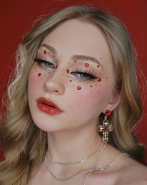 Valentines Makeup With Gems, Heart Tears Makeup, Eye Makeup With Hearts, Heart Festival Outfit, Heart Gems On Face, Red Jewels Makeup, Cupid Inspired Makeup, Red Gemstone Makeup, Queen Of Hearts Simple Makeup