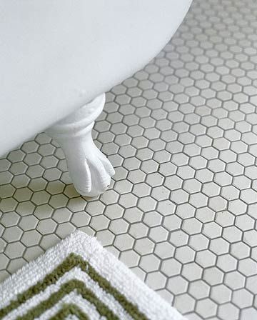 Hexagonal Tile FlooringHexagonal Tile Flooring  For design continuity throughout your home, consider matching flooring or other major elements in all of your bathrooms. In this remodeled bath, the homeowners chose new, unglazed hexagonal mosaic tiles to match those used in the home's other baths. White Hexagon Bathroom, Hexagon Bathroom Floor, Victorian Flooring, Hexagon Bathroom, Honeycomb Tile, Hex Tile, Hexagon Mosaic Tile, Victorian Interior, White Bath