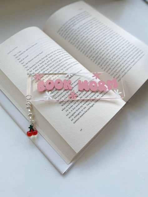 Bookworm Bookmark. Acrylic Bookmark with vinyl decal and bead charm Made using strong & durable 2mm acrylic  bookmark - 3.2cm/1.26inch x 12cm/4.72inch, 3.0mm thickness Pink wording with pearl beading and a cherry charm Note - The designs are HANDMADE AND FREEHAND. The product you receive might vary slightly from the picture. Cricut Keyrings, Acrylic Bookmarks Cricut, Booktok Bookmarks, Vinyl Bookmarks, Acrylic Bookmark Ideas, Cricut Bookmarks, Bookworm Bookmark, Bookmark Acrylic, Acrylic Bookmarks