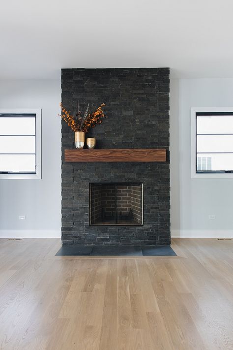 Dark stone fireplace Flanked by black windows, this dark stone fireplace features Slate stacked stone Mantel is made out of Walnut Dark stone fireplace Dark stone fireplace #Darkstonefireplace #stackedstonefireplace #stonefireplace #fireplace Dark Stone Fireplace, Black Brick Fireplace, Stone Fireplace Makeover, Fireplace Redo, Stacked Stone Fireplaces, Slate Fireplace, Fireplace Update, Brick Fireplace Makeover, Black Fireplace