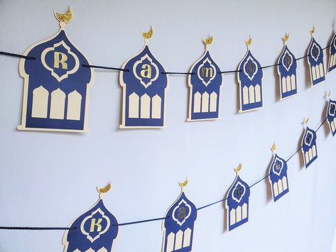 A double-layered navy blue & ivory banner with gold foil lettering. This classic design will be a fine choice for bringing in Ramadan feel at home.  What's included:  * Includes fully assembled garlands containing 'RAMADAN' & 'MUBARAK' * Each letter flag is 3 inches wide and 5.5 inches long * Custom colors available upon request ** Please select from the drop-down menu which items you would like to purchase REFUNDS/ RETURNS/ EXCHANGES: We do not offer refunds, returns, or exchanges. Please conta Ramadan Mubarak Banner, Ramadan Table Decor, Ramadan Table, Decoration Ramadan, Eid Mubarak Banner, Ribbon Flag, Ramadan Decorations, Hanging Decorations, Ramadan Mubarak