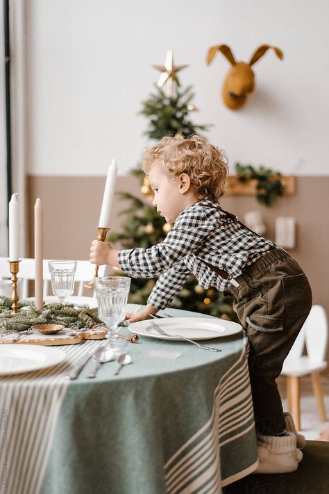 Side view of funny child holding candle near table with dishes, cutlery and glasses in decorated room with Christmas tree Plates And Cutlery, Christmas Instagram Pictures, Gingerbread Cottage, Decorated Room, Holding Candle, Xmas Photos, Christmas Shoot, Christmas Mini Sessions, Christmas Challenge