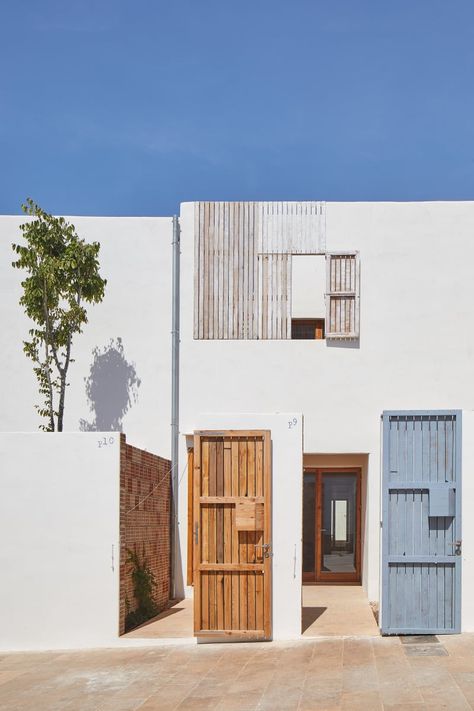 Carles Oliver, José Hevia · Formentera Social Housing Energy Efficient Buildings, Low Cost Housing, Wooden Shutters, Timber Door, The Proposal, Social Housing, Building Systems, Construction Cost, Balearic Islands