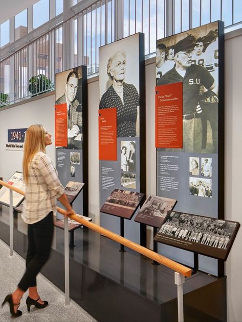 Exhibit design at the National Veterans Resource Center at Syracuse University in Syracuse, NY. Museum Exhibition Design Display, Experiential Graphics, Experiential Design, Graphic Panels, Museum Exhibition Design, History Wall, Syracuse University, Timeline Design, Exhibit Design