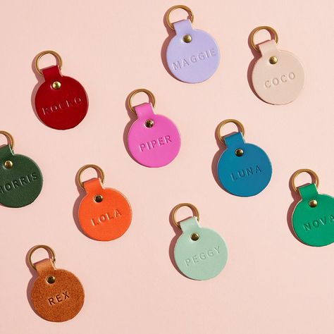 A colourful personalised leather name tag for your pet, the perfect treat for your dog this Christmas. Handmade from sustainably sourced, premium quality British leather and made in the UK, at our studio in the New Forest to be exact. Choose from a range of bright colours, soft pastels or classic neutrals. Each tag is supplied with a solid brass split ring (fancy) and can be stamped with your pet's name in traditionally debossed letters. For an extra £5 you can also personalise the back of the l Cute Dog Collars For Females, Dog Brands, Cool Dog Collars, Dog Tags For Dogs, Cute Dog Tags, Pet Name Tag, Pet Name Tags, Pet Tags Personalized, Dog Name Tags