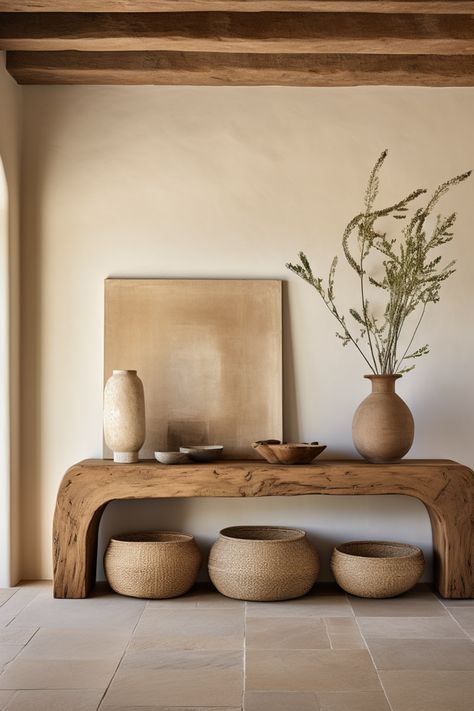 Discover curated charm in our entryway oasis, adorned with a rustic wooden console table, decorative baskets, and minimalist ceramics. Embracing the essence of southern countryside living, this space weaves earthy tones, emotive lighting, and the quaint allure of cottagecore. #CuratedCharm #RusticEntryway #SouthernAppeal #MinimalistDecor #CottagecoreInspiration #EarthTonePalette #DecorativeStools #EmotiveLighting #CountryLiving #HomeDesign Entryway Organic Modern, Rustic Organic Home Decor, Organic Earthy Interiors, Modern Organic Entryway Ideas, Boho Natural Living Room, Organic Design Interior, Earthy Tones Interior, Modern Organic Entryway, Organic Entryway