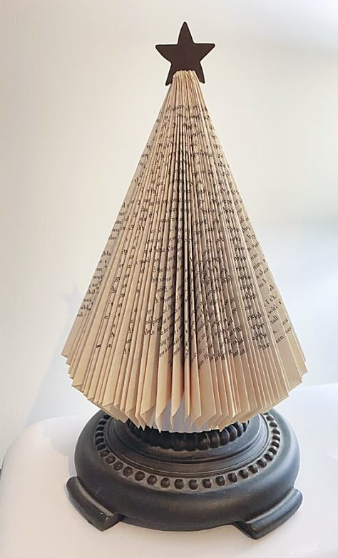 DIY book page trees with pedestal bases Vintage Book Christmas Tree, How To Make An Angel From A Book, Christmas Tree Folded Book, Crafts With Old Books Pages, Snowman Made From Books, Christmas Tree Made From Book Pages, Book Christmas Trees Diy, Book Pages Crafts Christmas, Folded Paper Trees