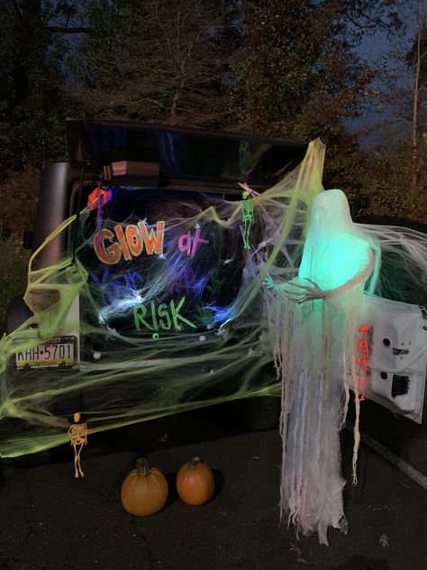 Glow themed trunk for trunk or treat! Had glow necklaces and let the kids play ring toss with them on the pumpkins. Used black light paint on a black sheet for the saying. Kids loved it! Trunk Or Treat Black Light, Glow Party Trunk Or Treat, Black Light Trunk Or Treat, Trunk Or Treat Glow In The Dark, Glow Trunk Or Treat, Glow In The Dark Trunk Or Treat, Neon Trunk Or Treat Ideas, Trunk For Trunk Or Treat, Trunk Or Treat Ideas