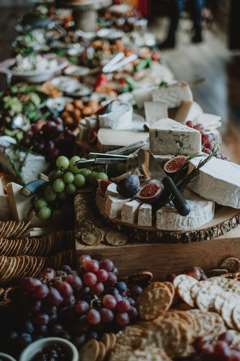 Wedding day grazing board with cheese, figs, crackers and grapes set on wooden boards across table Elegant Grazing Table Wedding, Cheese And Cracker Table For Wedding, Graze Board Wedding, Wedding Charcuterie Board On Each Table, Large Wedding Charcuterie Table, Wedding Food Charcuterie, Food On Wooden Board, Italian Grazing Table Ideas, Moody Grazing Table