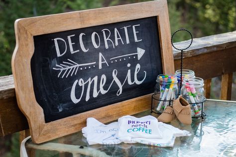 Decorate A Onsie Ideas, Decorate Onsies Ideas, Decorate Onesies Baby Shower Cute Ideas, Baby Shower Decorate Onesies, Onesie Station Baby Shower Ideas, Onesie Signing Station, Sign The Onesie, Baby Shower Onsies Signing, Baby Shower Onesie Decorating