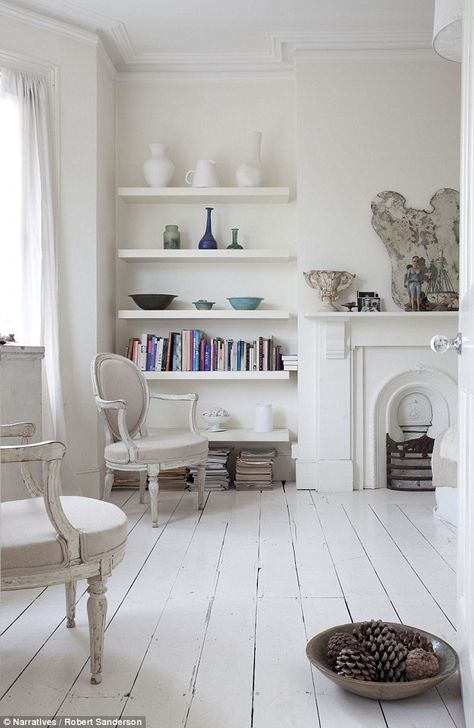 The living room is painted in predominantly milky shades with accent fabrics; the fireplace is a 20s version of a Regency style: ‘I love its details,’ says Josephine.Lassco sells reclaimed fireplaces White Painted Floors, White Floorboards, Painted Floorboards, White Wooden Floor, Floating Shelves Bedroom, Painted Wood Floors, White Wood Floors, Floating Shelves Living Room, Floating Shelves Kitchen