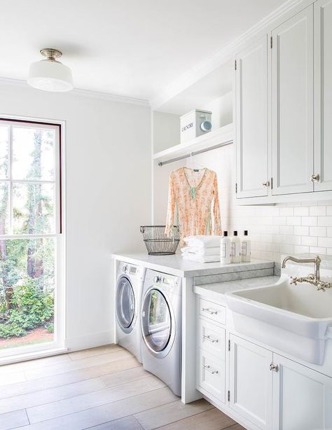 White laundry room features white cabinets adorned with vintage latch hardware paired with carrera marble countertops and a white subway tile backsplash. White Laundry Room, Farmhouse Laundry Room Ideas, Modern Farmhouse Laundry Room, Laundry Room Storage Shelves, White Laundry Rooms, Laundry Room/mud Room, Small Laundry Room Organization, Room Storage Diy, Dream Laundry Room