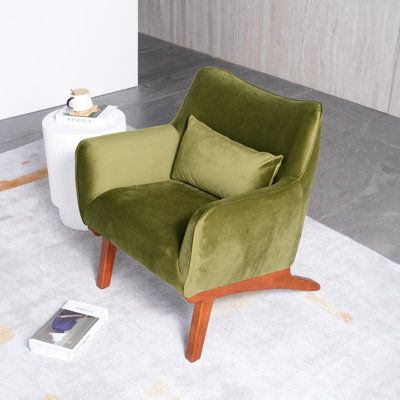 This mid-century modern armchair lets you add an extra spot to sit in the master suite, living room, or den. It's crafted with a kiln-dried solid eucalyptus wood frame that rests on solid wood legs with a hue. This chair is wrapped in a solid color fabric in your choice of hue. It strikes a sleek reclined silhouette with round arms and a fixed back. The seat is filled with foam and reinforced with pocket springs for extra support where you need it most. Plus, this armchair comes with a matching Mid Century Living Room Chairs, Mid Century Modern Chairs Living Room, Mid Century Modern Eclectic Living Room, Velvet Chairs Living Room, Mid Century Chairs Living Room, Mid Century Modern Eclectic, Suite Living Room, Modern Eclectic Living Room, Green Velvet Armchair