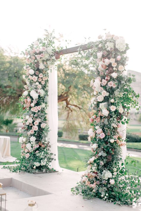 Square wedding arch covered with greenery and pink wedding flowers with view of water feature and golf course at Red Rock Country Club. White Blush Greenery Wedding, White And Blush Flower Arch, Wedding Arch Peonies, Greenery And Blush Wedding, Ivory And Greenery Wedding, Blush And Sage Wedding Arch, Sage Green And Blush Flower Arch, Blush And Sage Flowers, Wedding Decorations Ceremony Outdoor