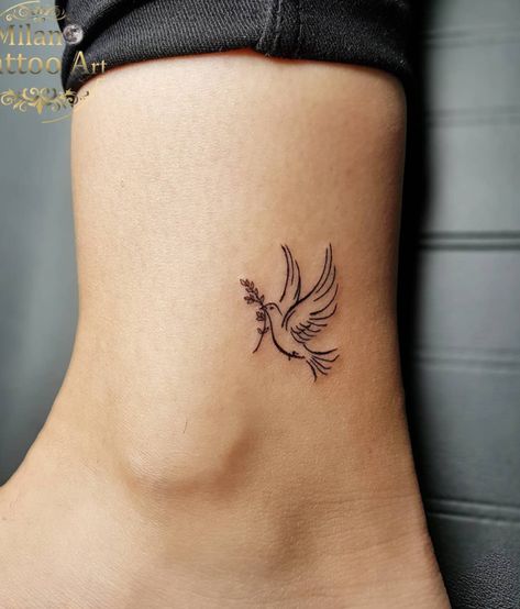 Pretty Dove Ankle Tattoo Idea Bird Tatoos Woman Wrist, Love Dove Tattoo, Small Dove Tattoo Design For Women, Dove With Olive Branch Tattoo Simple, Mini Tattoos Christian, Dove Flying Tattoo, Angel Tattoo Placement, Fe Tattoos For Women, Tiny Angel Wing Tattoo