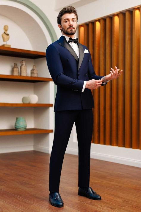 Enjoy the timeless appeal of this 2-piece navy double-breasted tuxedo suit. This suit radiates elegance and guarantees a professional and dapper appearance with its dominating 6-button blazer, peak lapels, and double vents. #tuxedo #navytuxedo #groom #navyslimfittuxedo #elegantstyle #sophisticatedlook #formalattire #refinedluxury #weddingattire Navy Blue Suit Men, Best Wedding Suits For Men, Marriage Suits, Indian Wedding Suits Men, Double Breasted Suit Men, Suit For Men Wedding, Designer Tuxedo, Indian Wedding Clothes For Men, Best Wedding Suits