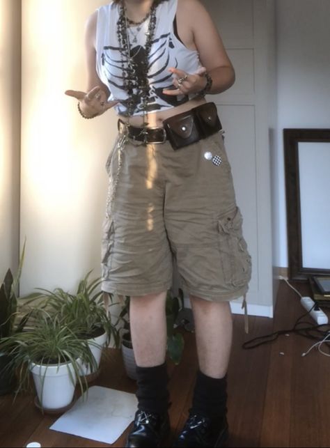 A mid-sized person/girl wearing cropped white rib cage t-shirt,  wide light brown cargo shorts, dark brown legwarmers, black platform dr. Martens and multiple crystal rings and bracelets. 		The person is also wearing multiple silver necklaces. Jorts Outfit Idea Alt, Ecopunk Outfit, Masc Grunge Outfits Summer, Gremlincore Outfits Summer, Crowcore Diy, Summer Outfit Alternative, Summer Outfits Punk, Earth Tone Summer Outfits, Punk Outfits Summer