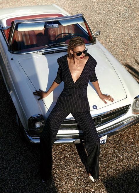 Posing on a convertible, Kelly Rohrbach models pinstriped pantsuit from Monse with Michael Kors sunglasses and Jimmy Choo heels Mode Poses, Car Editorial, Classic Car Photoshoot, Kelly Rohrbach, Cow Boys, Car Poses, Michael Kors Sunglasses, Model Pose, Jimmy Choo Heels