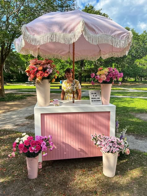 Our beloved flower cart has seen so many beautiful upgrades over the years! 🌸 Currently, it features an adorable pink and white umbrella with the sweetest fringe. Now, it's time for a change! What color umbrella should we choose next to keep our wedding floral arrangements fresh and enchanting? 🌷💐 Vote for your favorite and see the transformation with Doris Ione, your go-to wedding florist for dreamy floral designs! Flower Stand Ideas, Boutique Store Front Ideas, Cart With Umbrella, Flower Bar Ideas, Vendor Stand, Bouquet Bar, Wedding Floral Arrangements, Jewelry Booth, Girly Decor