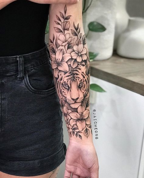 Full Sleeve Tattoos Women Tiger, Tiger Flower Sleeve Tattoo, What Does A Tiger Tattoo Represent, Tiger And Flower Tattoo Half Sleeves, Half Sleeve Tattoos For Women Upper Arm Tiger, Tiger And Bear Tattoo, Tiger And Flower Tattoo For Women, Flowers On Forearm Tattoo, Pretty Animal Tattoos