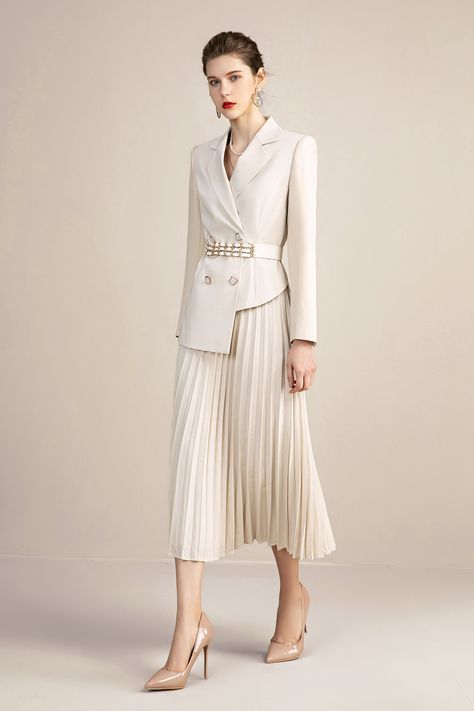 Stay on top of the fashion game with this sophisticated beige skirt suit. Crafted with a V-neck top and pleated skirt, this number will keep you looking stylish and feeling comfortable with its breathable fabric. Own your everyday look! Beige V-neck With Pleated Skirt Blazer Skirt Suits Peak lapels; front button blazer V-Neck, Long sleeves; button sleeves Structured shoulders. Chest welt pockets. Pleated Skirt V-Neck, Long sleeves; buttons Structured shoulders. Chest welt pockets. Hip flap pocke Collar Shirt With Long Skirt, Female Suit With Skirt, Blazer And Pleated Skirt Outfit, Suit And Skirt For Women, Long Skirt With Blazer, Pleated Skirt Outfit Formal, Satin Pleated Skirt Outfit, Blazer And Long Skirt, Frock Design Ideas