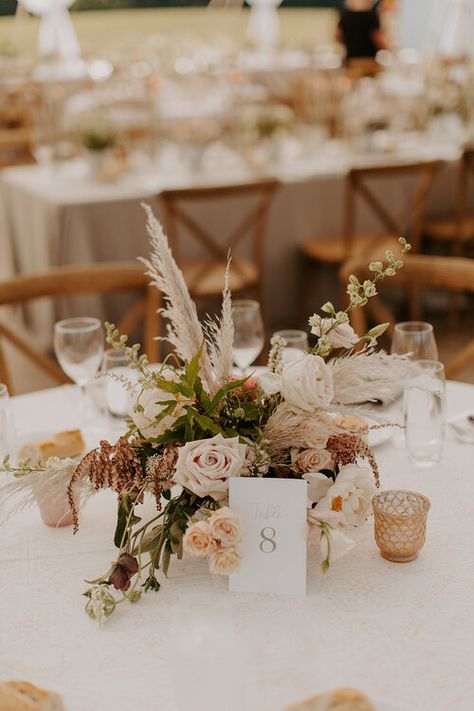 Floral centerpiece of muted blush tones and dried elements accented with blush mercury glass candles were center focal for the round guest tables. Jenna Borst Photography / Kate Elizabeth Brides Boho Wedding Centerpieces With Candles, Wedding Floral Centerpieces Circle Table, Round Table Wedding Centerpieces Boho, Round Boho Centerpiece, Boho Floral Centerpieces Wedding, Round Wedding Table Centrepiece, Wedding Guest Centerpieces, Round Boho Table Wedding, Boho Round Wedding Table