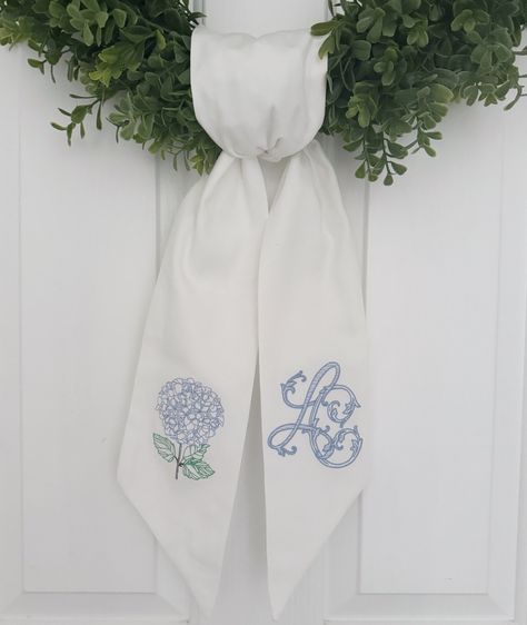 This beautiful hydrangea wreath sash will put the finishing touches on your front porch! It comes with an embroidered hydrangea on one side and a custom monogram on the other. Please message us with a photo of your desired monogram.  Measures approximately 52"x4.5" These are completely sewn by me, which means the embroidery will not be shown through on the other side.  Need a custom one? Send a message and we can help you come up with the perfect wreath sash. Embroidered Hydrangea, Jewish Artwork, Wreath Sash, Initial Wreath, Fairhope Al, Hydrangea Wreath, Wedding Sash, Custom Door, Monogram Gifts