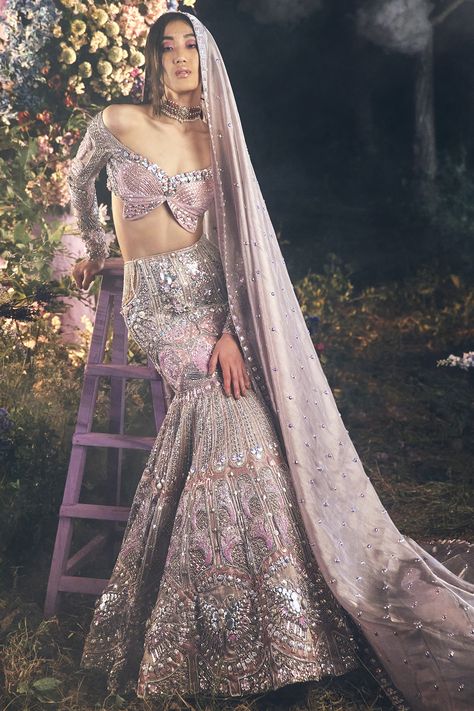 A 3-piece mermaid cut lehenga in lilac embroidered with silver metal embellishments, precious crystals, and 3D floral glass cut beads. This lehenga is completed with a waist side cut covered with tulle and silver embroidered tassels. It is paired with a signature Papa Don't Preach butterfly full-sleeved blouse appliqued in lilac silks. This look is completed with a tissue organza embroidered dupatta in lilac. #perniaspopupshop #whatiworewastrending #ppuslove #papadontpreach #rakhi #teej Papa Don't Preach, Metal Embellishments, Organza Sleeves, Embroidered Lehenga, Indian Bridal Outfits, Pink Bridal, Indian Wedding Outfits, Teal And Pink, Indian Wedding Dress