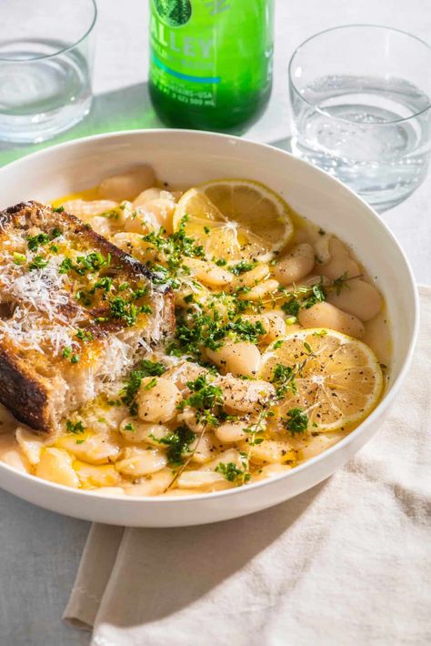 Creamy, brothy white beans cooked in savory chicken stock with lemon, olive oil, and parmesan cheese! Parmesan Cheese Sauce, Parmesan Rind, Lemon Olive Oil, Garlic Pasta, Roasted Mushrooms, Savory Chicken, Lentil Recipes, Good Healthy Snacks, Bowl Of Soup