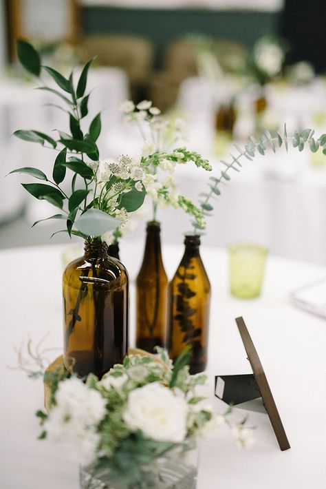 amber bottle centerpieces - photo by The Kama Photography https://ruffledblog.com/industrial-modern-wedding-with-a-greenery-wall Industrial Chic Wedding Flowers, No Candle Centerpieces Wedding, Industrial Modern Wedding, Affordable Wedding Centerpieces, Brass Wedding, Greenery Wedding Centerpieces, Rustic Wedding Decorations, Bottle Centerpieces, Brewery Wedding