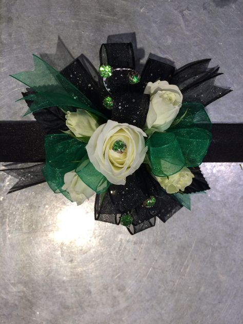 Emerald green and black sparkle ribbon corsage wristlet with white spray roses and black leaves and jewels Emerald Green And Black Corsage, Black And Green Corsage, Emerald Green Corsage, Prom Necessities, Hoco Accessories, Green Corsage, Prom 2k22, Prom 2k24, Corsage Wristlet