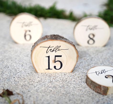 PRICES MAY VARY. Want to have something different and unique for your wedding?! These engraved aspen wood standing slices stand up on each table and have a nice rustic feeling touch to them. Each piece is unique as there will never be two of the same wood slice. Size:Diameter: 4" inches (approximate); Thickness: 3/4-1" inches (approximate). These tree slices are cut on bottom edge and then engraved for a great table decoration. Use them at your cake table, guest book table, or on each table at y Wood Rounds For Centerpieces, Lotr Table Numbers, Whimsical Wedding Tablescape, Simple Fall Centerpieces Wedding, Olive Green And Gold Wedding, Wood Wedding Centerpieces, Wood Table Setting, Welcome Table Wedding Entrance, Barn Wedding Table Decor