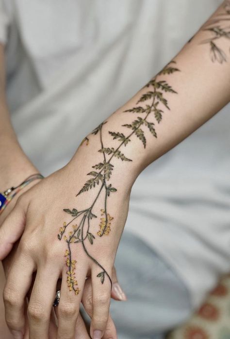 Nature's poetry etched in ink: Anna Botyk's botanical tattoo designs tell a story of blossoms, leaves, and delicate details. 🌺💉 Join me in exploring the enchantment of these nature-inspired masterpieces. Greenery Neck Tattoo, Hand Fern Tattoo, Herb Sleeve Tattoo, Green Vine Tattoos For Women, Nature Hand Tattoos For Women, Vines On Hand Tattoo, Green Thumb Tattoo, Fern Hand Tattoo, Greenery Tattoos