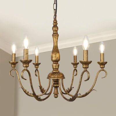 Are you looking for a pendant light that exudes elegance and classic charm? Let us introduce you to our Classic French Country Antique Brass Pendant Light, which features six delicate candle-shaped sockets and embodies the charm of vintage brass in classic French country style. Whether you want to create a romantic atmosphere, host cozy family gatherings, or need soft lighting for reading, our Classic French Country Vintage Brass Pendant Light is perfect for your needs. House of Hampton® Finish: Antique Brass | House of Hampton® Josuel 6 - Light Chandelier 19.68 H x 23.62 W x 23.62 D in yellowMetal in Antique Brass | 19.68" H X 23.62" W X 23.62" D | Wayfair Traditional Country Dining Room, English Country Chandelier, Vintage Looking Chandelier, French Cottage Farmhouse Decor, Off Center Chandelier Dining Room, Brass And Crystal Chandelier, Antique Brass Chandelier Dining Rooms, Styling With Antiques, French Cottage Lighting