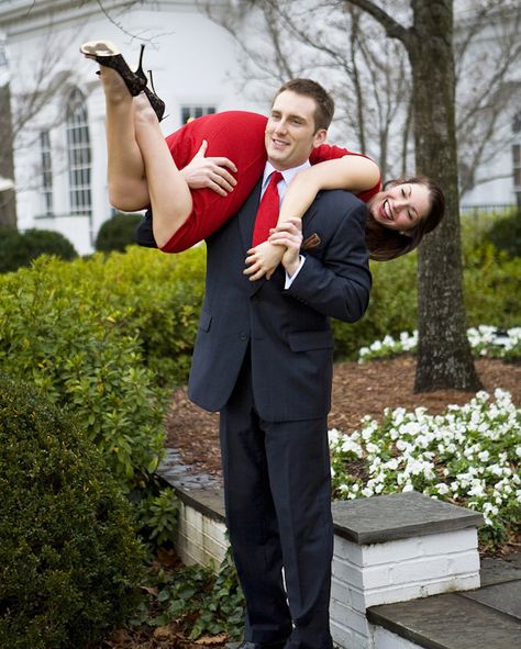 engagement photo of the happy couple - the fiance is carrying his fiancee over his shoulder - photo by North Carolina based wedding photographers Cunningham Photo Artists Holding Someone Over Shoulder Reference, Over The Shoulder Carry Couple, Thrown Over Shoulder Pose Couple, Carry Over Shoulder Couple, Carrying Someone On Shoulders Pose, Carrying Over Shoulder Pose Reference, Boy Carrying Girl Over Shoulder, Carry On Shoulder Pose, Carried Over Shoulder Couple