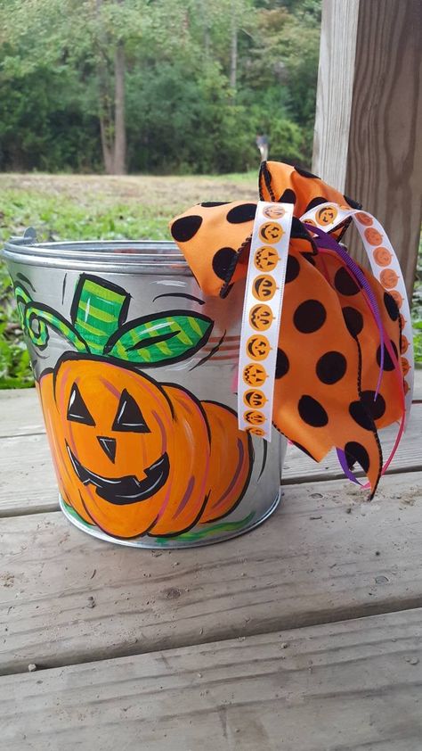 "Tin Pails are painted to fit your needs! This listing is for the Happy Jack! Boy or Girl or neutral! I put a sealer on all buckets. That way you can re use them next year or use them for toy storage! Please include name of child if you would like that added to pail. If you dont like polka dots just put in note to seller and I will leave them off! Please specify if you want name on side of pumpkin or back of pail and color. MESSAGE ME AND WE WILL CREATE WHATEVER YOU DREAM UP! Also available for Painted Halloween Buckets, Painted Buckets Ideas, Halloween Buckets Ideas, Diy Halloween Buckets, Metal Bucket Ideas, Painted Metal Buckets, Personalized Halloween Bucket, Painted Buckets, Hand Painted Halloween