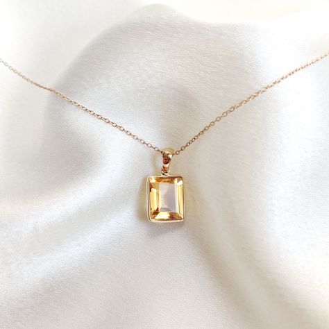 This stunning Pendant is set in 14k Solid Yellow Gold with Natural Citrine with utmost precision. It is a unique gemstone Pendant for nearly every occasion and is completely hassle-free jewelry. ITEM DETAILS: * Gem: Citrine * Gem Size: 9X11mm * Gem Shape: Octagon * Gem Weight: 4.30 carats * Gold Purity: 14KT * Gold Weight: 0.54 gram * Total Weight of the Pendant: 1.40 gram The Gold purity is guaranteed and it comes with authentic 14KT gold hallmark. Since my items are handmade, they are absolutely nickel and lead free. CUSTOMIZATION: * Gemstone customization is available and it can be substituted with a gem of your choice. Kindly message me for the same. PACKAGING * The Pendant comes with layers of safe and secure wrapping along with Free handmade jewelry box with every purchase. ➡️Head to Sunny Disposition, Yellow Hues, Handmade Jewelry Box, Tanzanite Earrings, Citrine Jewelry, Citrine Pendant, Personalized Pendant, Bezel Pendant, Birthstone Pendant