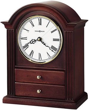 The addition of two felt-lined jewelry drawers make the Howard Miller Kayla 635-112 Mantel Clock a thoughtful and unique choice. Fluted columns, and a polished brass tone bezel create a classic appeal. Beneath the convex glass crystal lies an off-white dial with black Roman numerals and black serpentine hands. Finished in Windsor Cherry on select hardwoods and veneers with Quartz movement. Fluted Columns, Fake Plants Decor, Mantle Shelf, Howard Miller, Carriage Clocks, Jewelry Drawer, Shelf Clock, Table Clocks, Mantel Clocks