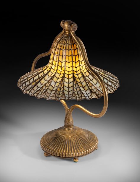 <p>Louis Comfort Tiffany, Artistry in Glass: The Seymour and Evelyn Holtzman Collection</p><p>Tiffany Studios</p><p>"Lotus" Table Lamp</p><p><br></p><p>circa 1915</p><p>leaded glass, gilt bronze</p><p>shade impressed <em>TIFFANY STUDIOS NEW YORK 422</em></p><p>base impressed <em>TIFFANY STUDIOS/NEW YORK/422</em></p><p>20 ½ in. (52.1 cm) high</p><p>15 in. (38.1 cm) diameter of shade</p> Tiffany Studios, Louis Comfort Tiffany, Tiffany Glass, Leaded Glass, 20th Century, Lotus, Table Lamp, Shades, Glass