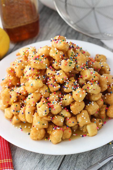 Struffoli are fried dough balls that are covered in honey and sprinkles, all served in a mound. This golden sweet treat is an Italian Christmas staple. Struffoli are made from simple ingredients with easy prep, but taste anything but! Honey Balls Recipe, Fried Dough Balls, Struffoli Recipe, Honey Balls, Italian Desserts Traditional, Italian Christmas Cookies, Italian Cookie Recipes, Italian Dessert, Delicious Deserts