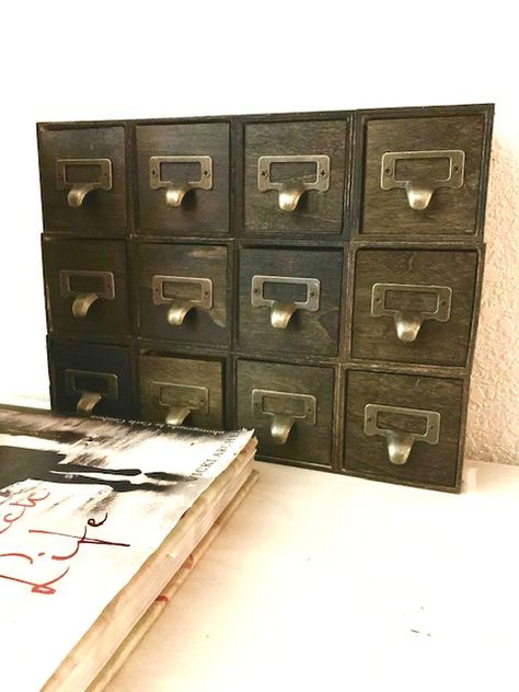 DIY Apothecary cabinet using Dollar Tree wood cubes! I used Dollar Tree wood craft cubes, hot glue, stain, & vintage handles to create this vintage styled cabinet. Check out the blog for more pics and to see how i did it. Dollar Tree Wood Craft Cubes Ideas, Dollar Tree Apothecary, Diy Apothecary Cabinet, Apothecary Cabinet Diy, Styled Cabinet, Apothecary Diy, Diy Apothecary, Vintage Handles, Crafting Techniques