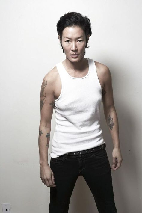 Jenny Shimizu, in this photo found on Tumblr, is a good example of a modern masculine lesbian. Very open about her sexuality, Shimizu is wearing a wife beater shirt while standing in a very masculine pose. Making her very in touch with masculine lesbian. Wife Beater Outfit, Andro Style, Wife Beater Shirt, Jenny Shimizu, Tomboy Swag, Lacey Bra, Wife Beaters, Androgynous Models, Tom Boy