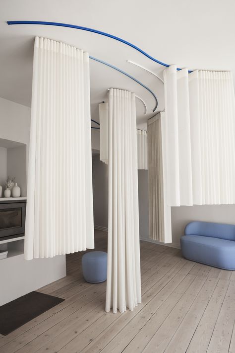 Blue and white ceiling mounted curtain tracks carrying white curtains. Curtain Room Dividers, Room Division, How To Hang Curtains, Curtain Divider, Interior Design Curtains, Curtain Tracks, Wave Curtains, Ceiling Curtains, Blue Ceilings