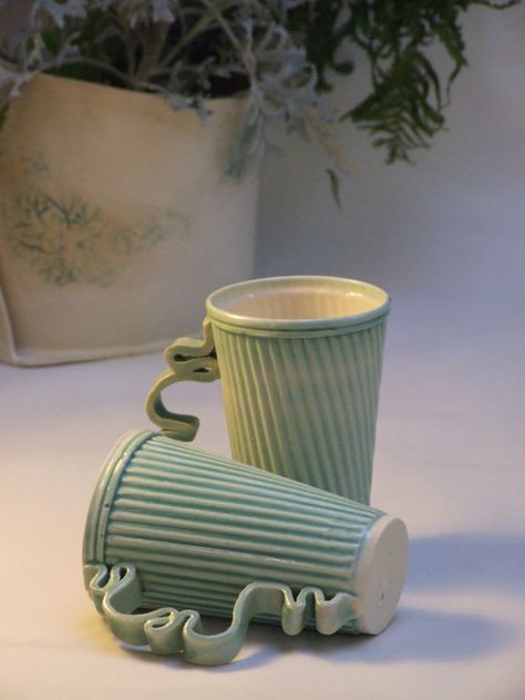 Pair of stoneware ceramic mugs in green by HelenRebeccaCerami Mugs With Cool Handles Ceramics, Ceramic Cups With Handles, Curvy Ceramic Mug, Cool Handles On Mugs, Interesting Mug Shapes, Mugs Out Of Clay, Ceramic Mugs With Cool Handles, Interesting Mug Handles, Textured Ceramic Mugs