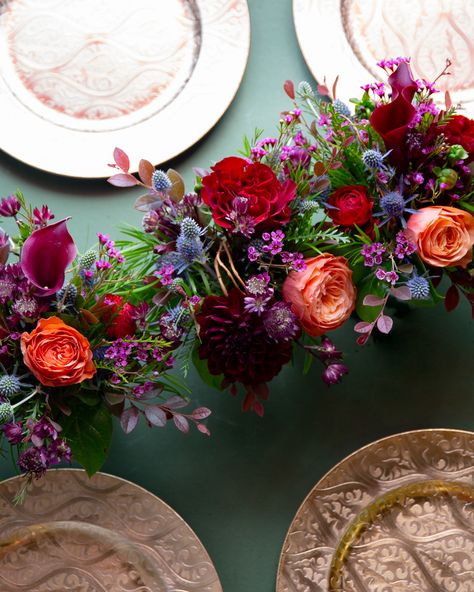 Artfully hand-designed, these three petite arrangements feature cranberry calla lilies, red roses, red ranunculus, burgundy dahlias, and peach roses in 4 inch cylinder glass vases. These arrangements are perfect for trailing along your table during your next fall gathering, or place it separately around the house to bring the rich hues of autumn indoors! Dimensions: Approximately 6" width x 5 1/2" height per vase Wedding Round Table Settings Colorful, Jewel Tone Wedding Flowers, Wedding Aisles, Jewel Tone Wedding, Fall Floral Arrangements, Wedding Entrance, Wedding Aisle, Wedding Mood, Wedding Napkins