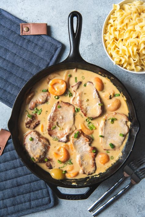 Creamy Apricot Pork Chops are a sweet and savory dish where pan-seared pork chops are cooked in a creamy sauce until tender and served over egg noodles for a perfect weeknight meal for the family in less than 30 minutes. Apricot Pork Chops, Apricot Pork, Mexican Drink Recipes, Pot Roast Sandwiches, Austrian Food, Southern Tomato Pie, Pan Seared Pork Chops, Apricot Recipes, Seared Pork Chops